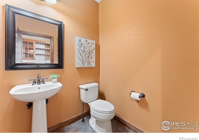 8276 Blackwood Dr, Windsor, CO 80550 - half bath featuring toilet and tile patterned floors