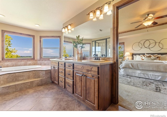 8276 Blackwood Dr, Windsor, CO 80550 - bathroom featuring connected bathroom, double vanity, tile patterned flooring, a bath, and ceiling fan