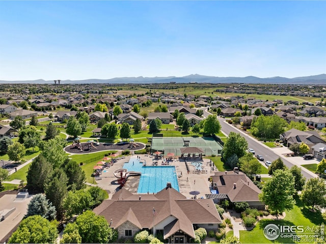 8276 Blackwood Dr, Windsor, CO 80550 - aerial perspective of suburban area featuring a pool and a mountain backdrop