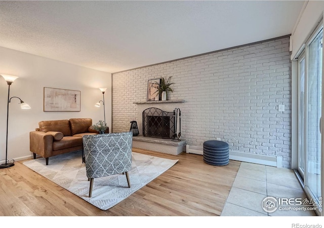 3030 Oneal Pkwy # 21R, Boulder, CO 80301 - living room featuring light wood-type flooring, brick wall, and a brick fireplace