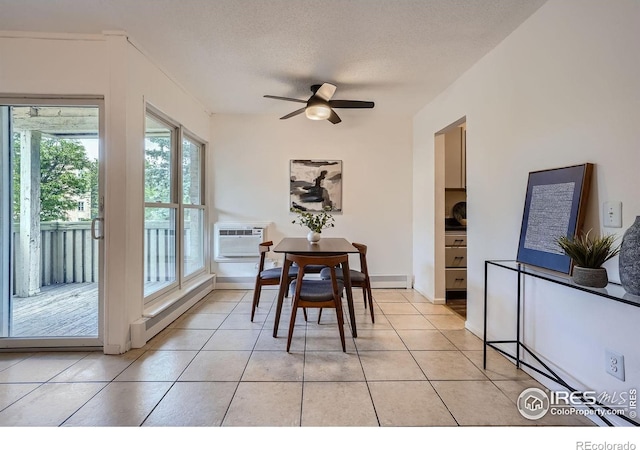 3030 Oneal Pkwy # 21R, Boulder, CO 80301 - dining area with a ceiling fan, a wall unit AC, light tile patterned floors, a baseboard radiator, and a textured ceiling