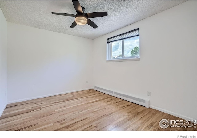 3030 Oneal Pkwy # 21R, Boulder, CO 80301 - spare room with a baseboard radiator, a textured ceiling, wood finished floors, and ceiling fan