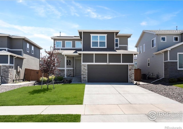 1228 104th Avenue Ct, Greeley, CO 80634 - view of front of home featuring stone siding, an attached garage, and concrete driveway
