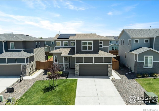 1228 104th Avenue Ct, Greeley, CO 80634 - view of front of home with a residential view, stone siding, concrete driveway, and solar panels