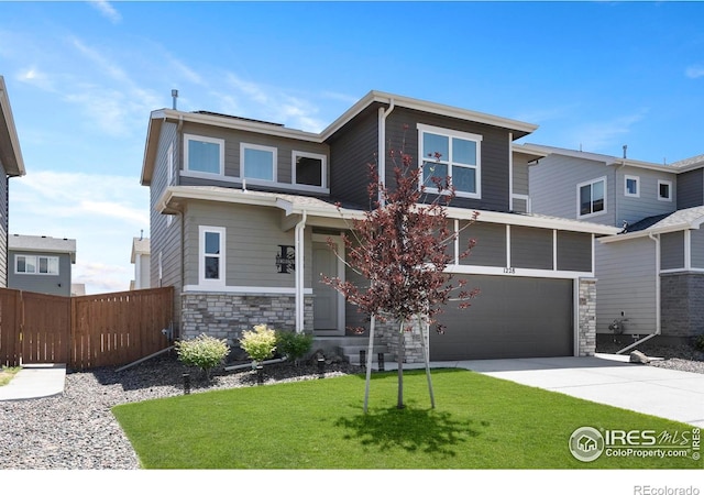 1228 104th Avenue Ct, Greeley, CO 80634 - view of front of property with stone siding, an attached garage, and concrete driveway