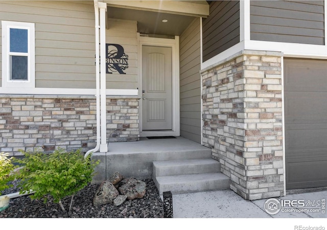 1228 104th Avenue Ct, Greeley, CO 80634 - property entrance with a garage and stone siding