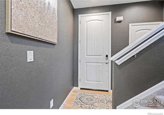 1228 104th Avenue Ct, Greeley, CO 80634 - entryway with a textured wall and wood finished floors