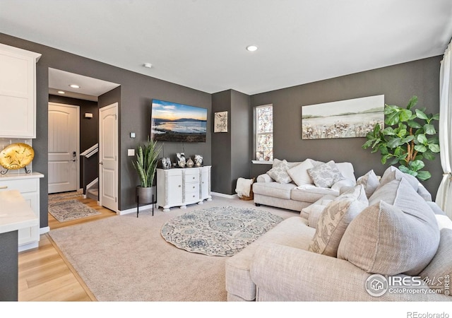 1228 104th Avenue Ct, Greeley, CO 80634 - living room featuring recessed lighting, light wood-style floors, and stairs