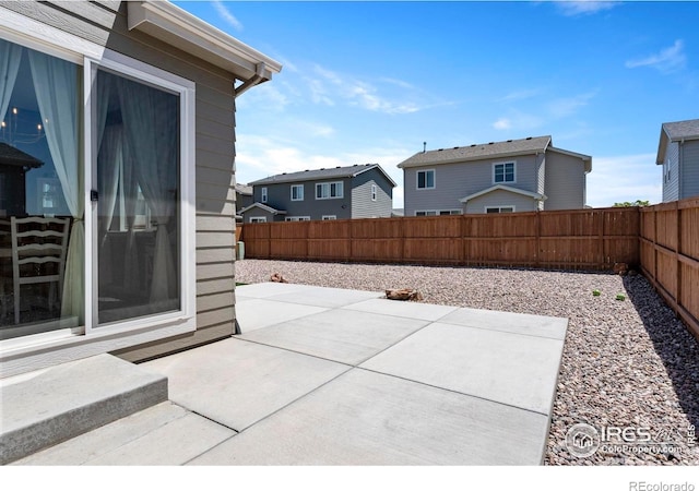 1228 104th Avenue Ct, Greeley, CO 80634 - fenced backyard with a patio area and a residential view