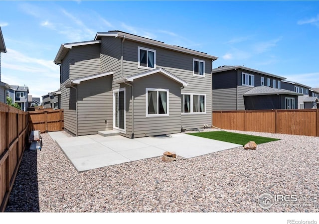 1228 104th Avenue Ct, Greeley, CO 80634 - back of property with a fenced backyard, a patio area, and a residential view