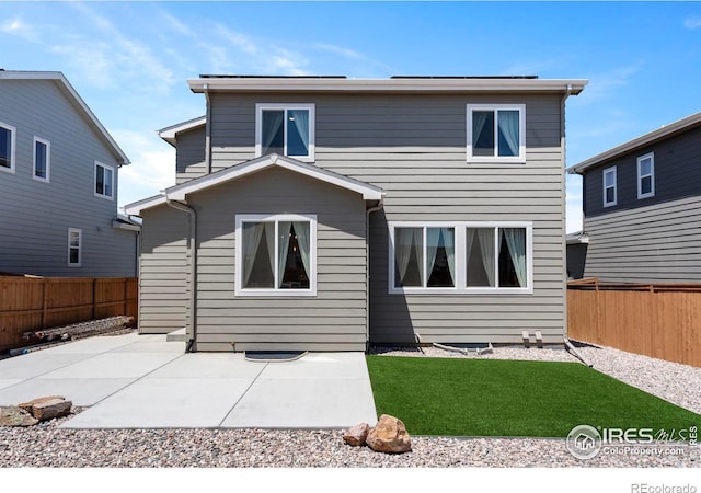 1228 104th Avenue Ct, Greeley, CO 80634 - rear view of house featuring a fenced backyard and a patio