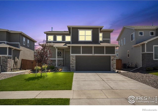 1228 104th Avenue Ct, Greeley, CO 80634 - view of front of home featuring an attached garage, driveway, and stone siding