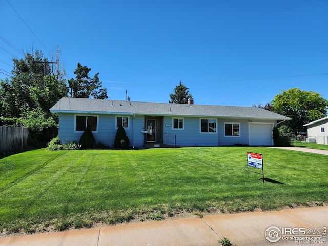 1107 Delmar St, Sterling, CO 80751 - ranch-style house featuring a garage and driveway