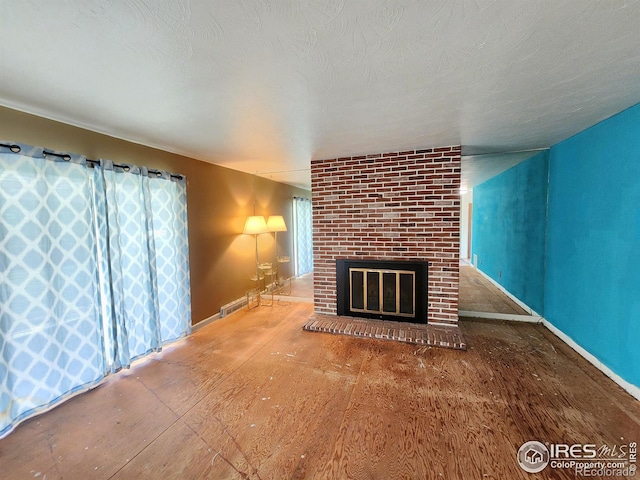 1107 Delmar St, Sterling, CO 80751 - unfurnished living room featuring a brick fireplace and baseboards