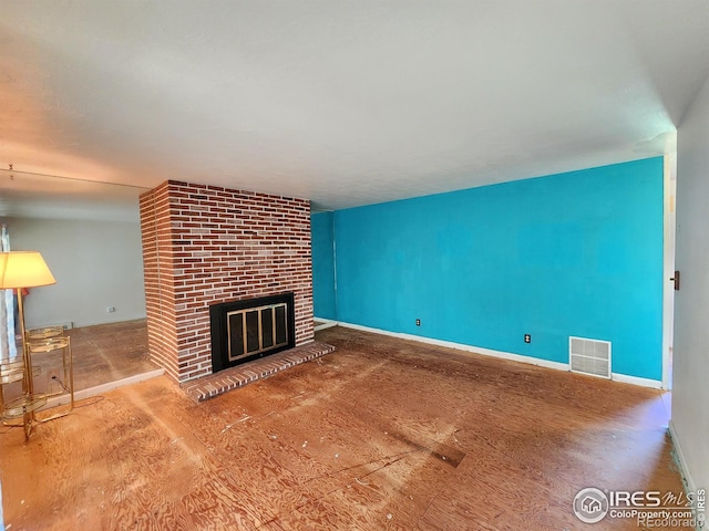 1107 Delmar St, Sterling, CO 80751 - unfurnished living room with a brick fireplace and baseboards