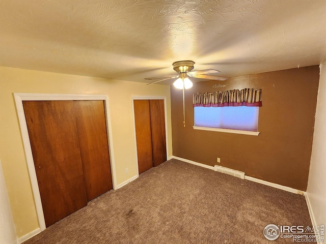 1107 Delmar St, Sterling, CO 80751 - unfurnished bedroom with carpet flooring, multiple closets, and ceiling fan