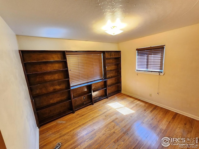 1107 Delmar St, Sterling, CO 80751 - unfurnished living room with wood-type flooring and baseboards