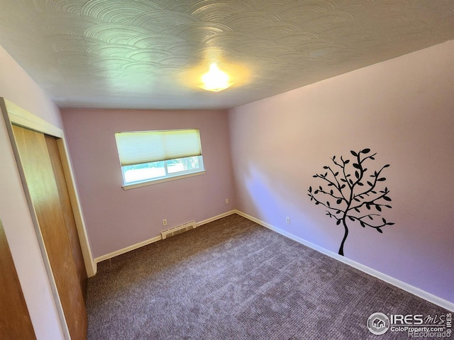 1107 Delmar St, Sterling, CO 80751 - unfurnished bedroom featuring dark carpet and a closet