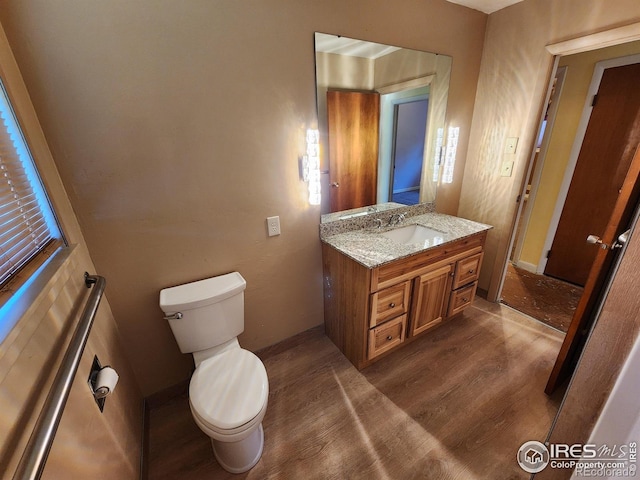 1107 Delmar St, Sterling, CO 80751 - half bath featuring vanity and wood finished floors