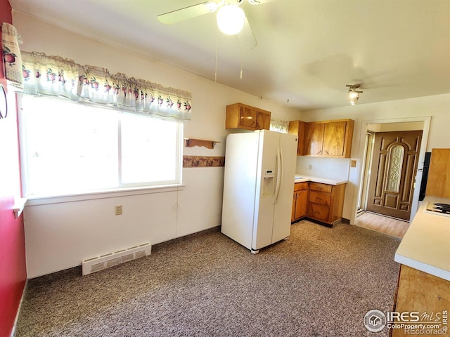 1107 Delmar St, Sterling, CO 80751 - kitchen featuring white appliances, brown cabinets, a ceiling fan, and light countertops