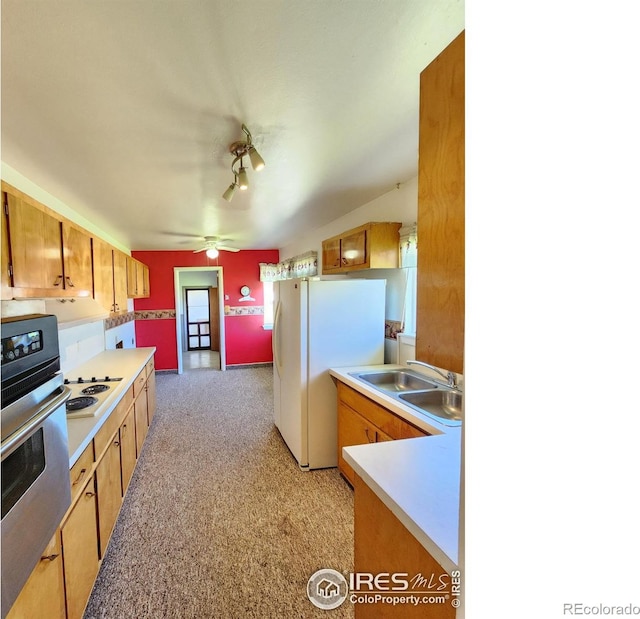1107 Delmar St, Sterling, CO 80751 - kitchen with white appliances, light countertops, ceiling fan, and brown cabinetry