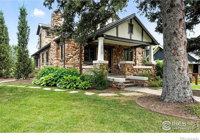 2958 6th St, Boulder, CO 80304 - view of front of property with stone siding, a porch, and a front yard