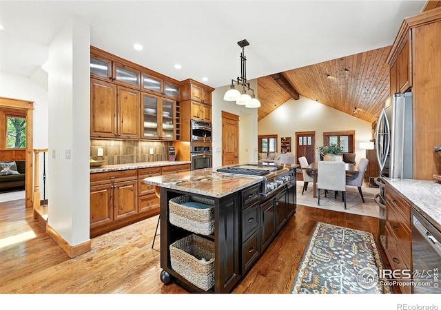 2958 6th St, Boulder, CO 80304 - kitchen with stainless steel appliances, brown cabinetry, tasteful backsplash, light wood-style flooring, and hanging light fixtures