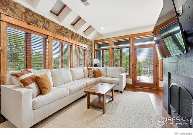 2958 6th St, Boulder, CO 80304 - living room featuring healthy amount of natural light, a tiled fireplace, light wood finished floors, and lofted ceiling