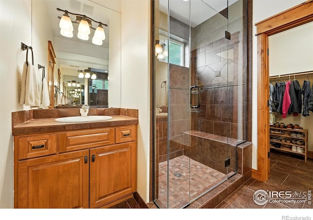 2958 6th St, Boulder, CO 80304 - bathroom featuring vanity, a stall shower, a spacious closet, and tile patterned floors