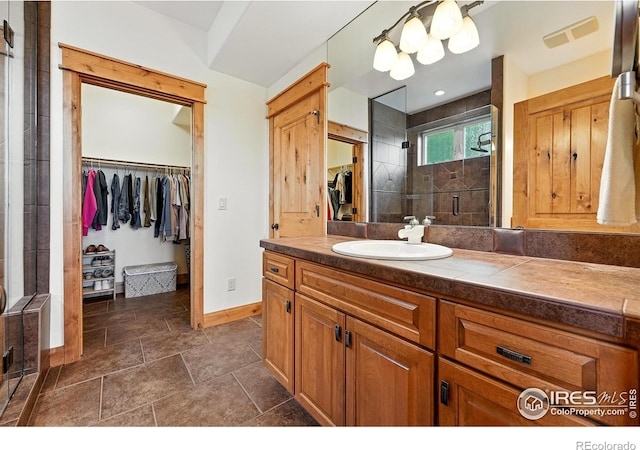 2958 6th St, Boulder, CO 80304 - bathroom featuring vanity, a shower stall, and a walk in closet