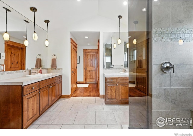 2958 6th St, Boulder, CO 80304 - bathroom with two vanities, recessed lighting, tile patterned floors, a tile shower, and vaulted ceiling