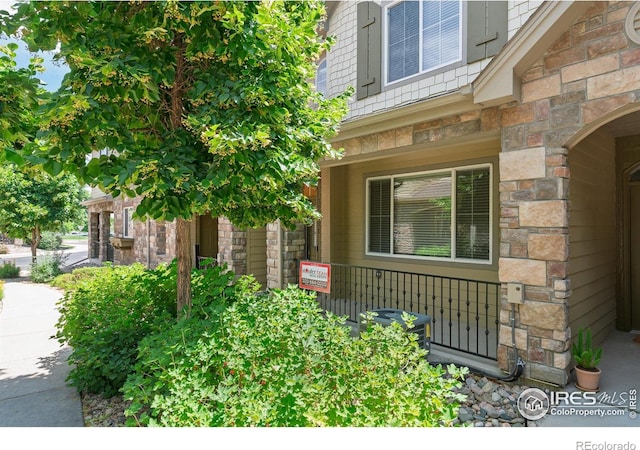 15233 W 65th Ave Unit C, Arvada, CO 80007 - property entrance featuring stone siding