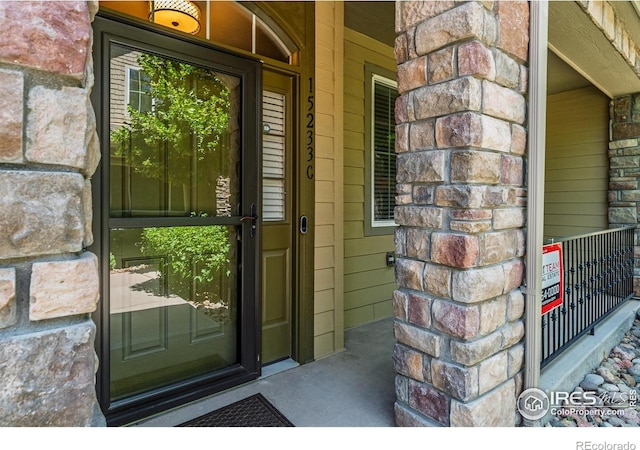 15233 W 65th Ave Unit C, Arvada, CO 80007 - doorway to property with a porch and stone siding