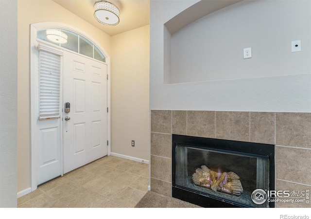 15233 W 65th Ave Unit C, Arvada, CO 80007 - tiled entryway with a fireplace and baseboards