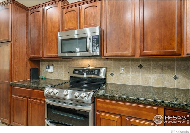 15233 W 65th Ave Unit C, Arvada, CO 80007 - kitchen featuring stainless steel appliances, decorative backsplash, and brown cabinets