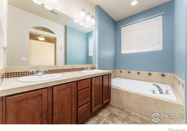 15233 W 65th Ave Unit C, Arvada, CO 80007 - bathroom featuring double vanity, a garden tub, and a ceiling fan
