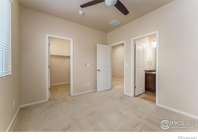 15233 W 65th Ave Unit C, Arvada, CO 80007 - unfurnished bedroom with carpet, a walk in closet, ensuite bath, a closet, and a ceiling fan