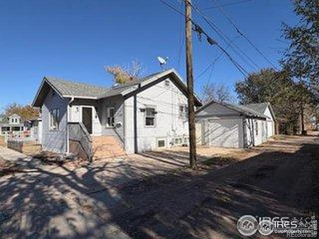 709 S 2nd Ave S, Sterling, CO 80751 - view of front of property featuring a detached garage and an outdoor structure