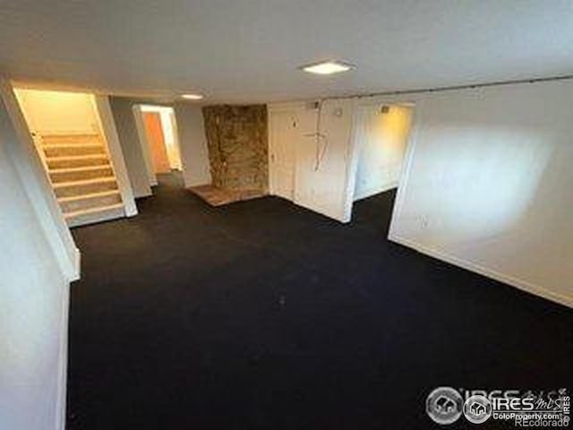 709 S 2nd Ave S, Sterling, CO 80751 - spare room with stairway and dark carpet