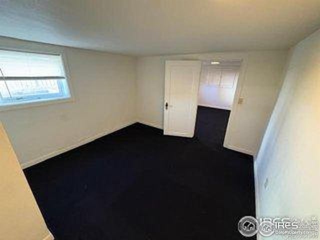 709 S 2nd Ave S, Sterling, CO 80751 - empty room with dark colored carpet