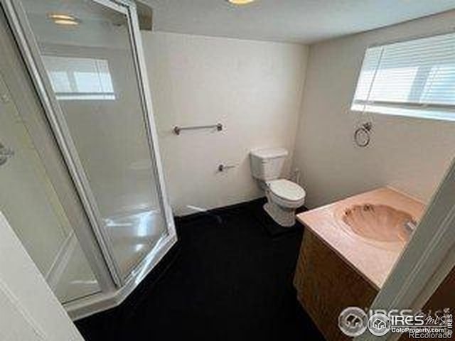 709 S 2nd Ave S, Sterling, CO 80751 - bathroom featuring vanity and a stall shower