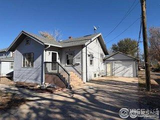 709 S 2nd Ave S, Sterling, CO 80751 - view of front facade with concrete driveway, an outbuilding, and a garage