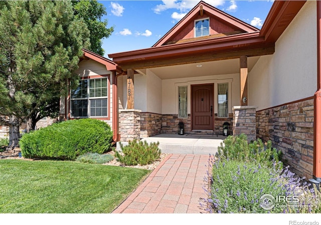 1787 Gore Creek Ct, Windsor, CO 80550 - property entrance featuring stone siding, stucco siding, and a porch