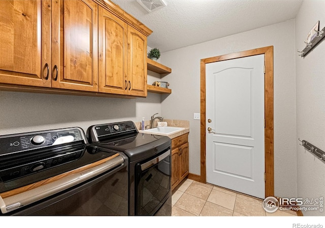 1787 Gore Creek Ct, Windsor, CO 80550 - laundry room with independent washer and dryer, cabinet space, light tile patterned floors, and a textured ceiling