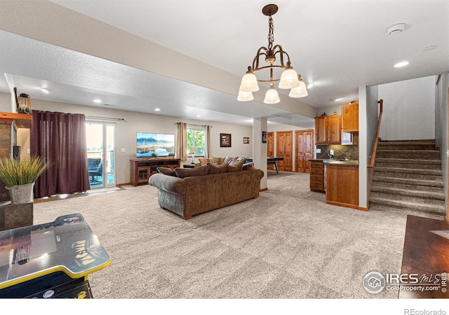 1787 Gore Creek Ct, Windsor, CO 80550 - living room with light colored carpet, stairs, a chandelier, and recessed lighting