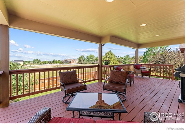 1787 Gore Creek Ct, Windsor, CO 80550 - wooden deck with an outdoor hangout area