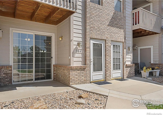 5151 29th St W Unit 204, Greeley, CO 80634 - property entrance featuring brick siding and a balcony