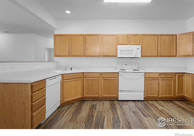 5151 29th St W Unit 204, Greeley, CO 80634 - kitchen featuring white appliances, a peninsula, light countertops, dark wood finished floors, and recessed lighting