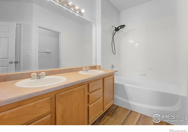 5151 29th St W Unit 204, Greeley, CO 80634 - full bathroom with double vanity, wood finished floors, and shower / tub combination