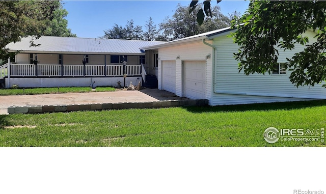 15296 County Road 39, Sterling, CO 80751 - rear view of house with a yard, an attached garage, and a porch